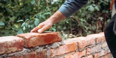 How do you build a brick retaining wall