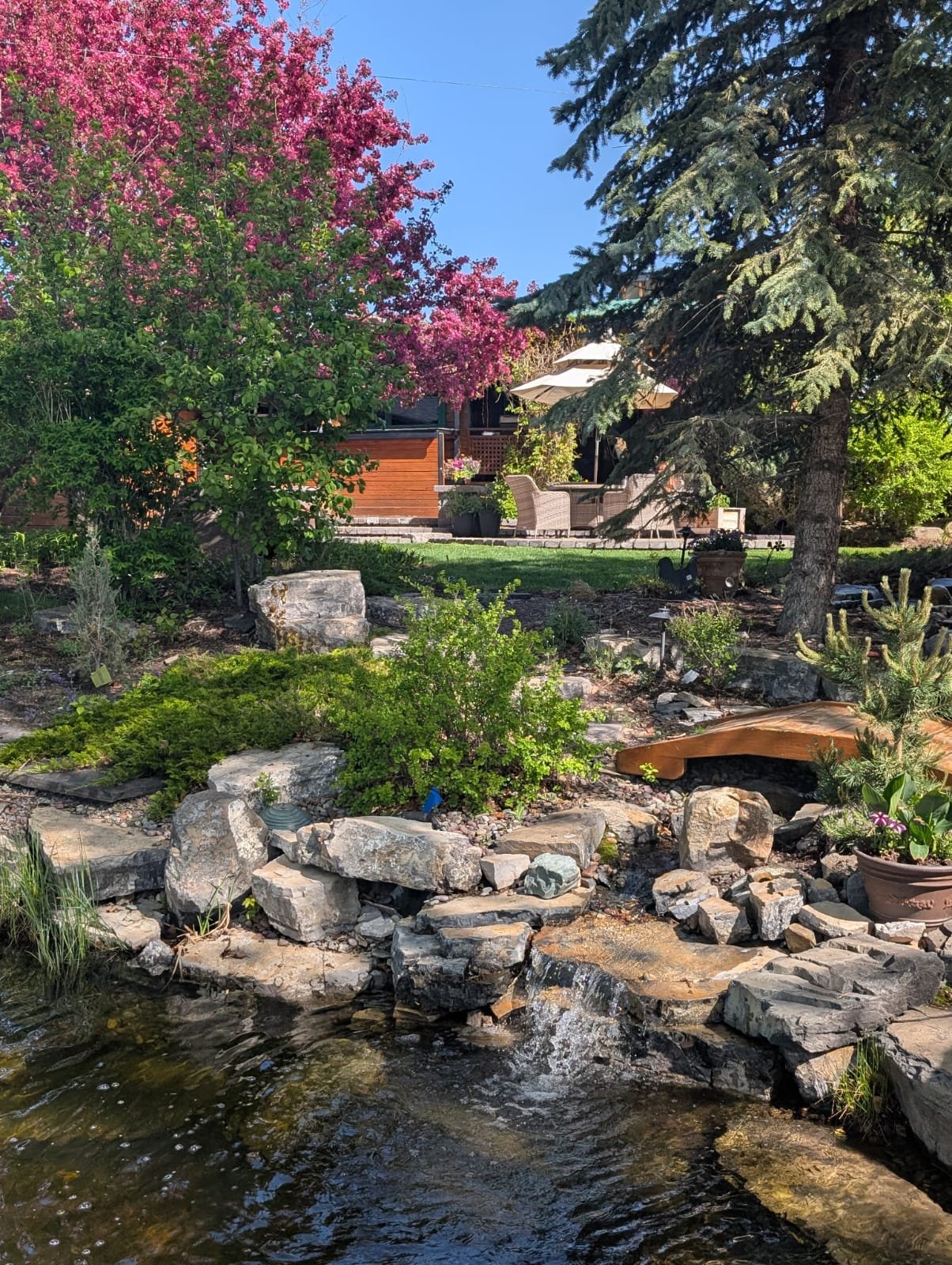 Modular block retaining wall with integrated stone steps in Calgary by Sungreen.