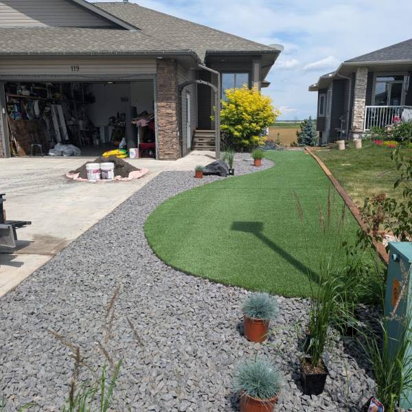 Paving-stone driveway in front of a Calgary home with a flowering tree, built by Sungreen.