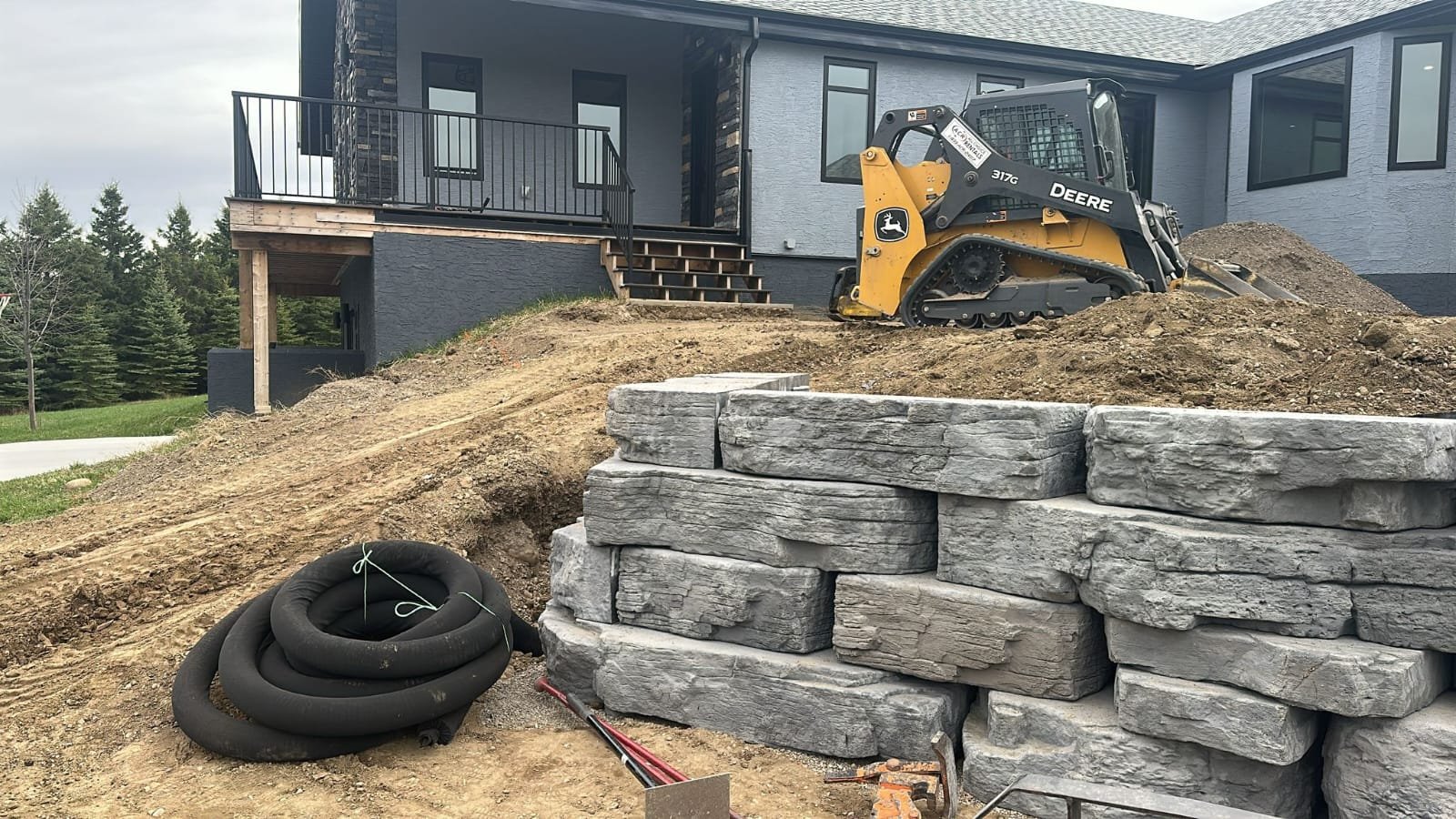 Driveway base preparation and grading in Calgary before paver installation by Sungreen.