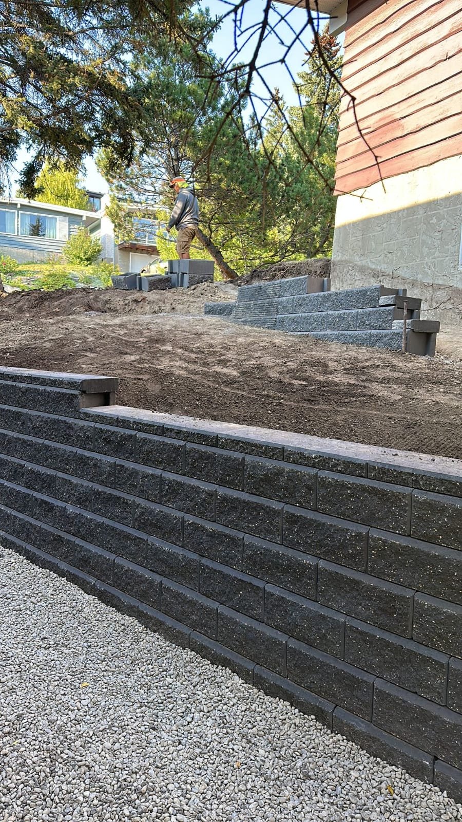 Modular concrete-block retaining wall running along a Calgary driveway by Sungreen.