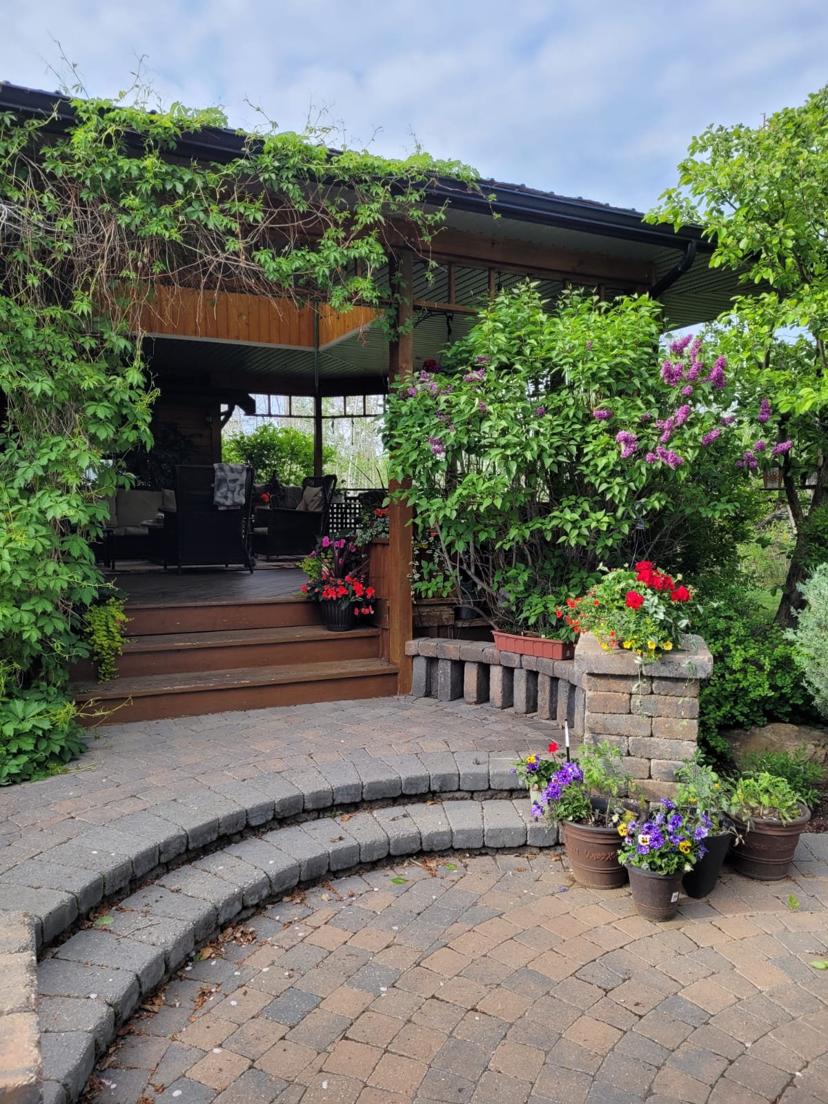 Sungreen Landscaping cedar pergola and paver patio — landscaping services in Okotoks, Alberta.