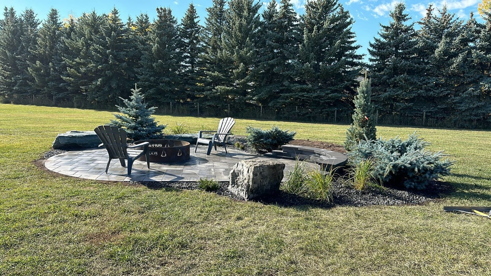 Ecosystem pond under construction in Calgary with boulder placement and liner work by Sungreen.