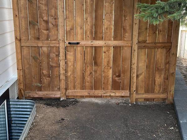 Wood privacy fence beside a paver path in a Calgary backyard by Sungreen.